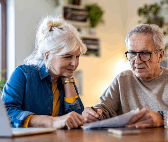 Senior couple sitting at the table discussing home finances