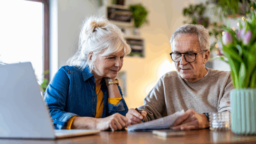 Senior couple sitting at the table discussing home finances