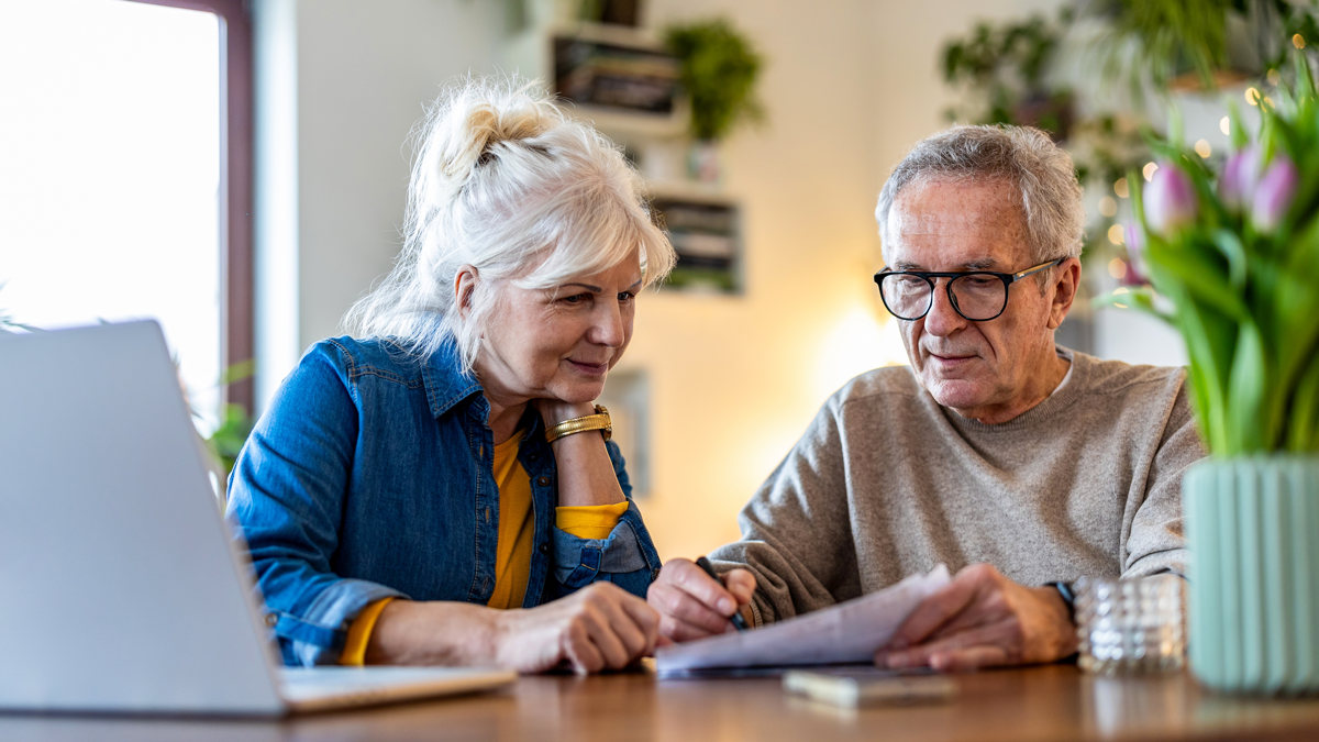 Senior couple sitting at the table discussing home finances