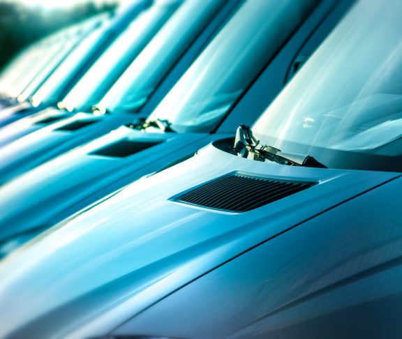 close up of white vans in a row, transportation concept