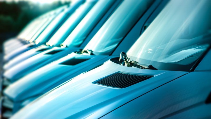 close up of white vans in a row, transportation concept