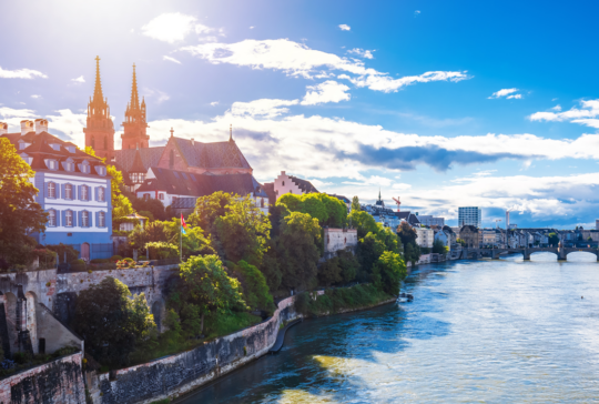 Rhine river and Munster cathedral in Basel sun haze view from the bridge, northwestern Switzerland