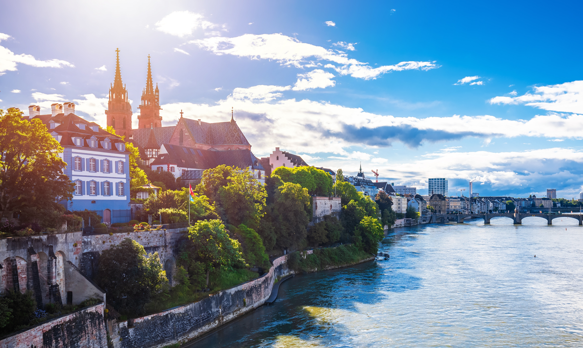 Rhine river and Munster cathedral in Basel sun haze view from the bridge, northwestern Switzerland