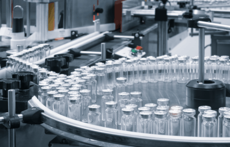 Pharmaceutical industry. Production line machine conveyor with glass bottles ampoules at factory. Pharmaceutical industry concept background