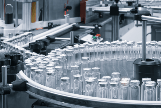 Pharmaceutical industry. Production line machine conveyor with glass bottles ampoules at factory. Pharmaceutical industry concept background