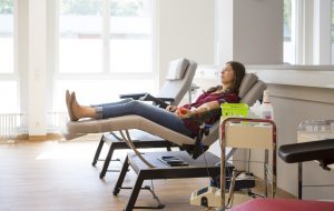 young woman lay on back while she is donating blood