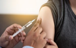 Medicine and health care concept Doctor giving patient vaccine insulin or vaccination