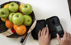 Diabetic young women performing a glucose level blood test at home