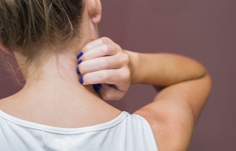 Great concept of allergy and skin diseases, young woman scratching herself.