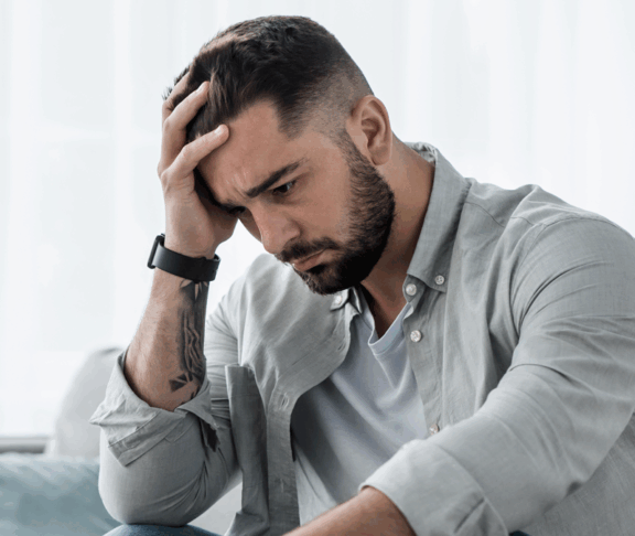Attraktive Kerl Gefühl verzweifelt, traurig, Blick beunruhigt depressiv nachdenklich und einsam leiden Depressionen auf der Couch zu Hause im mittleren Alter Krise, psychische Gesundheit persönliche Probleme und Lebensstil