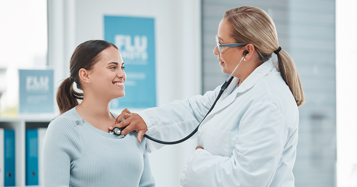 Shot of a doctor examining a patient with a stethoscope during a consultation in a clinic