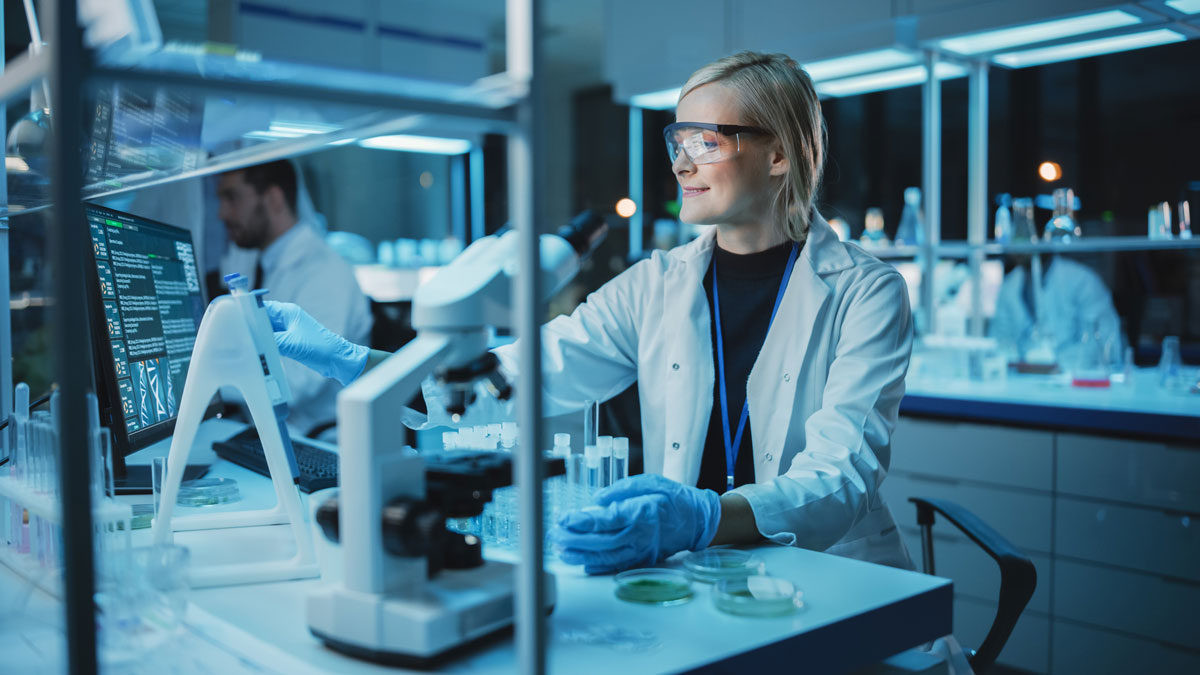Female Research Scientist Uses Micropipette to Mix Liquids in a Sample Test Tube in a Modern Laboratory. Scientists are Conducting DNA Research with the Help of Technology, Microscopes and Computers