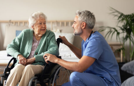 Caregiver doing regular check-up of senior woman in her home.