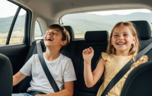 Two happy children enjoying a road trip adventure in the back seat