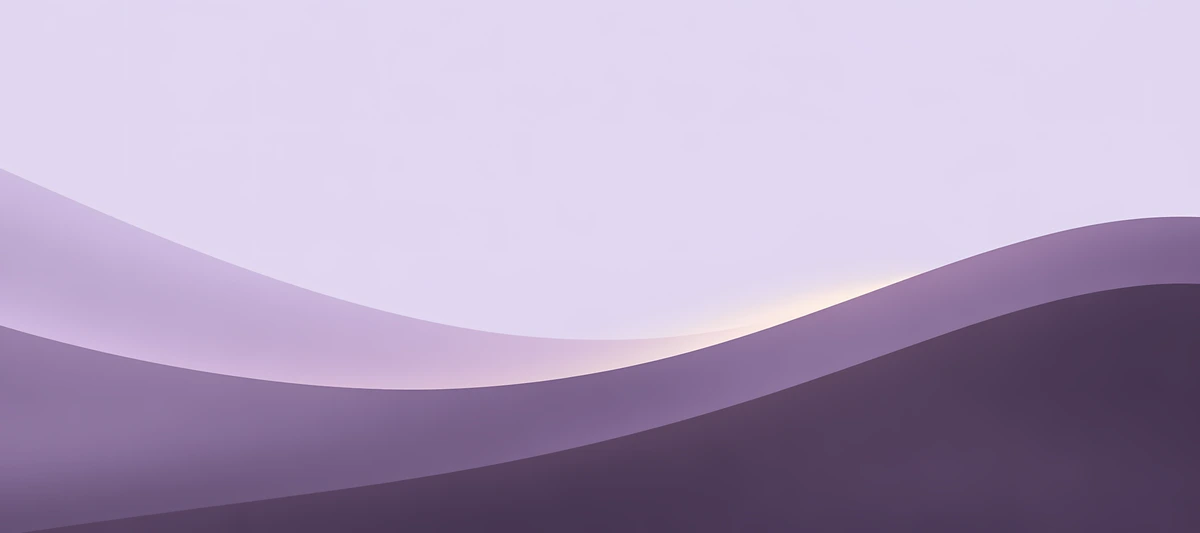 Overlapping lilac and dark violet curves rise beneath a pale lavender sky with a faint warm horizon glow., 90x40cm desk mat preview