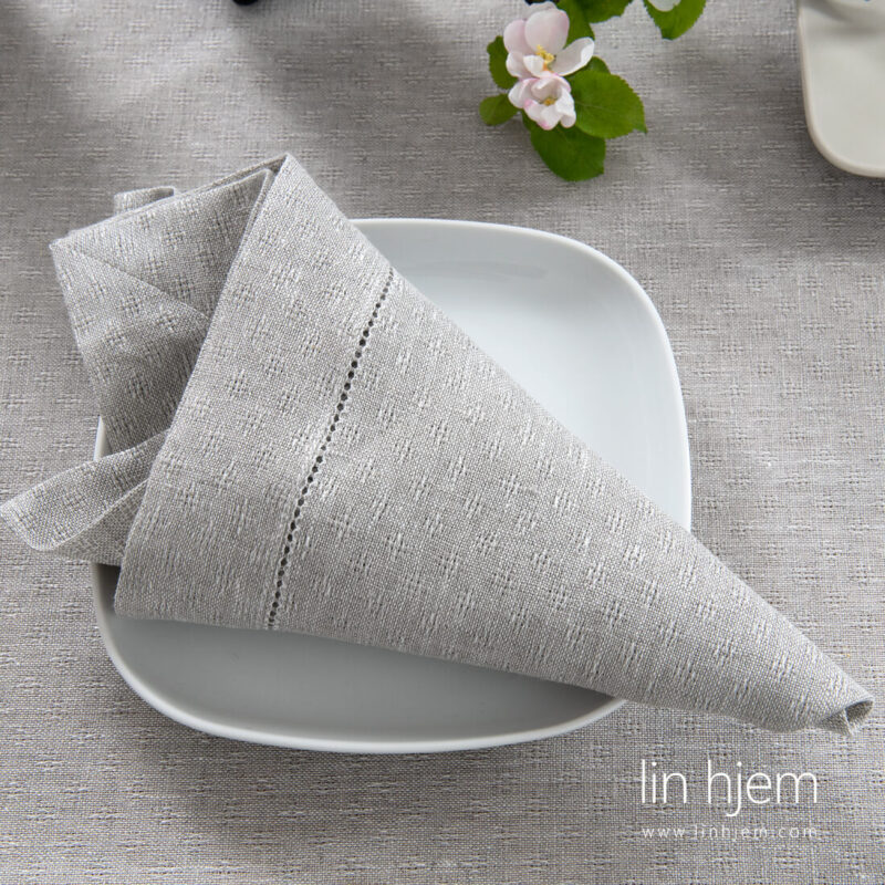 Hullm&oslash;nstret linserviett i lys gr&aring; farge.