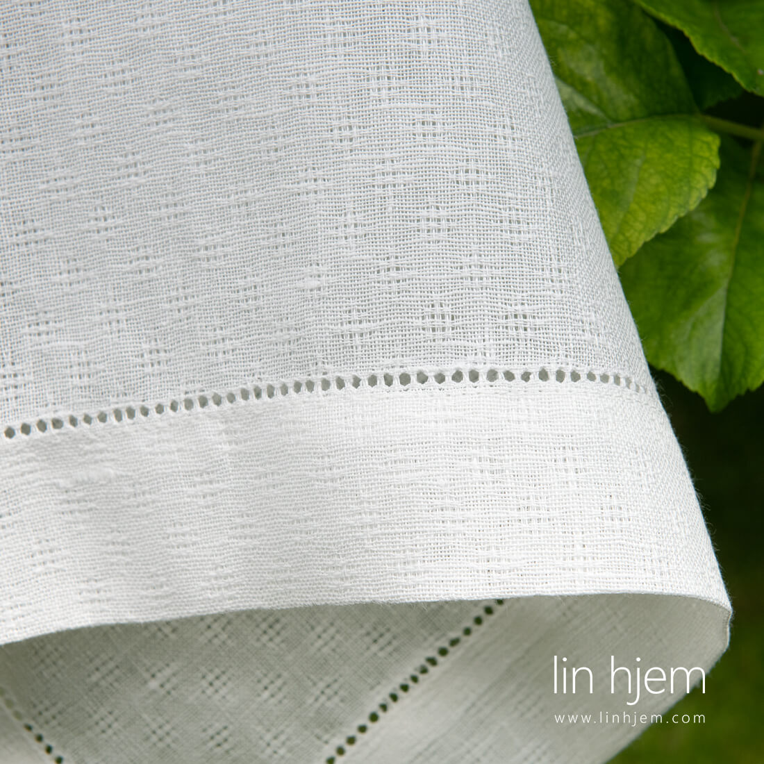 Hullmønstret linduk i hvit farge.