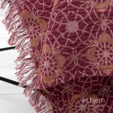 Rødt og gult linpledd, mønstret.