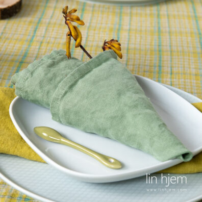 Grønnaktig serviett i vasket lin.