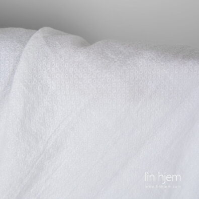 Mønstrete vasket linstoff i kritthvit.