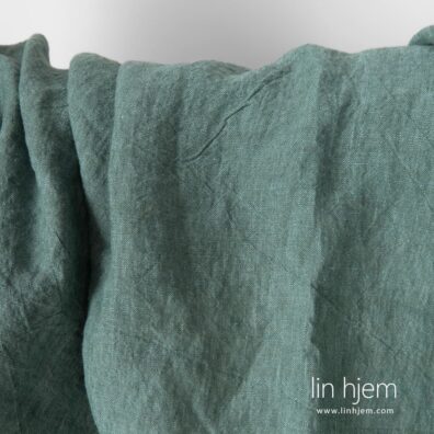 Vasket bredt linstoff i grønn farge.