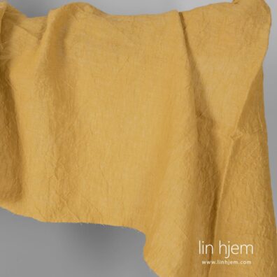 Bredt vasket gult linstoff.