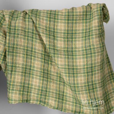 Bredt vasket linstoff i grønne ruter.