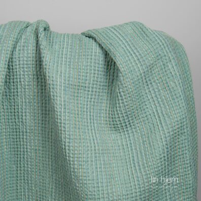 Halvlin vasket grønt stoff.