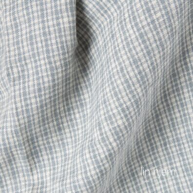 Lin-ull vasket stoff i grå ruter.