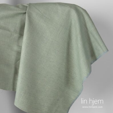 Halvlin stoff med grønne romber.