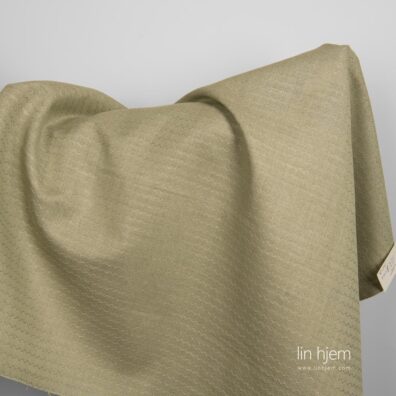 Halvlin grønt stoff med bølger.