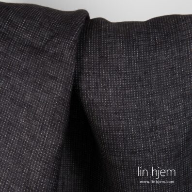 Prikket linstoff i grå svart farge.