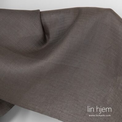 Mønstret grått-brunt linstoff.