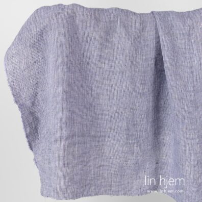 Vasket linstoff med svarte og lilla ruter.