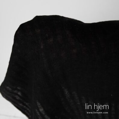 Vasket stripete svart linstoff.