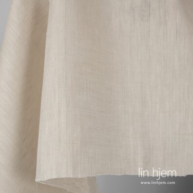 Brunaktig gult linstoff, mønstret.