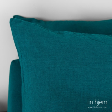 Dynetrekk, putetrekk og laken laget av intens blått med grønn nyanse linstoff.