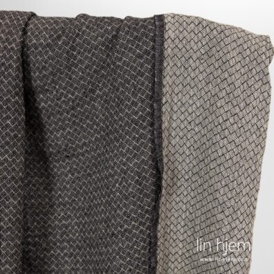 Mønstret brunaktig svart linstoff.
