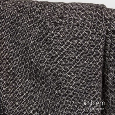 Mønstret vasket brunaktig svart linstoff.