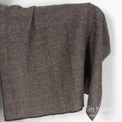 Vasket mønstret svart halvlin stoff.