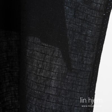 Mønstret linstoff i svart farge.