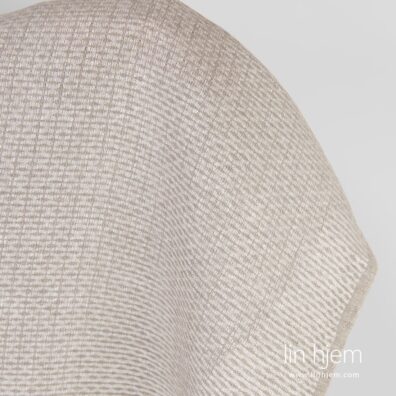 Mønstret lysegrått linstoff.