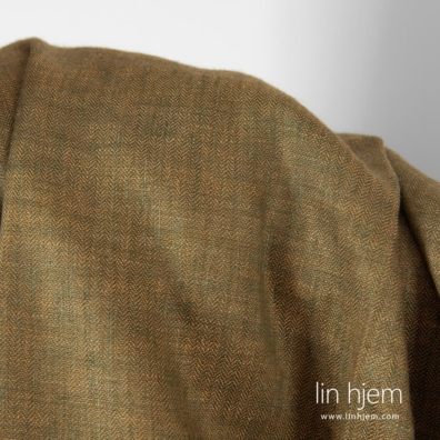 Linstoff i brun og mørkegrønt fiskebeinsmønster