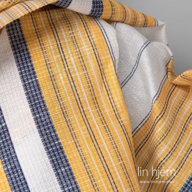 Halvlin stoff vaffel vevd av knallhvitt, gult og marineblått garn