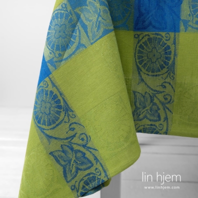 Grønn lin-bomull duk med blå ruter og plantemotiver