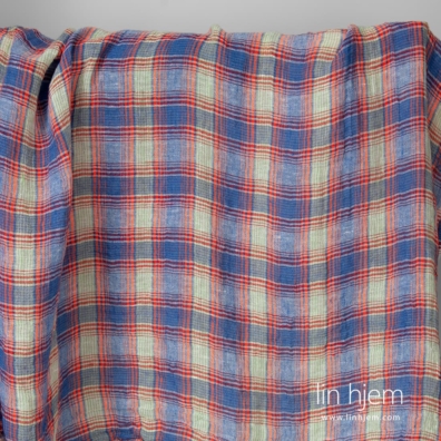 Gjennomsiktig linstoff i blå og oransje ruter vasket