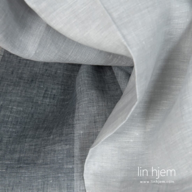 Linstoff vevd av flertonet grått og knallhvitt garn, melange med fargeovergang