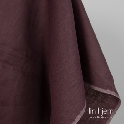 Linstoff vevd av mørkebrunt og mørklilla garn, melange