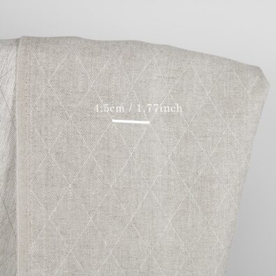 Beige dobbeltsidig linstoff med rombemotiv 150cm bredt