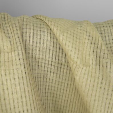 Grønnlig-gult linstoff i gjennomsiktige ruter 150cm bredt